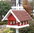 Vogellhaus Futterhaus aus der Landhaus Serie in steingrau weiß mit rotem Schindeldach